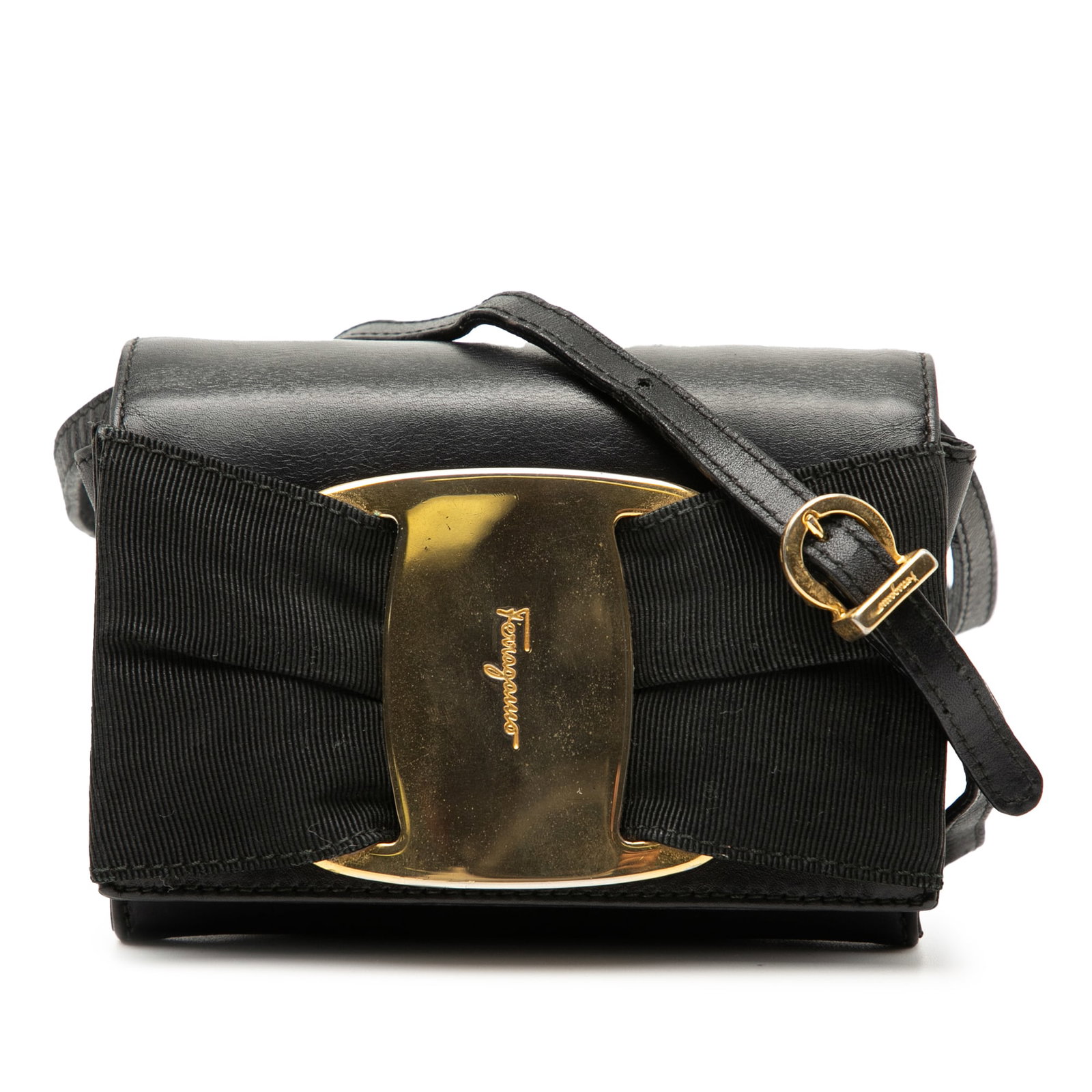 Salvatore Ferragamo Vara Bow Mini Black Leather Crossbody Bag: Salvatore Ferragamo Vara Bow Mini Black Leather Crossbody Bag This mini crossbody bag features a black leather body adorned with a signature bow detail, an adjustable flat leather strap, and a front f