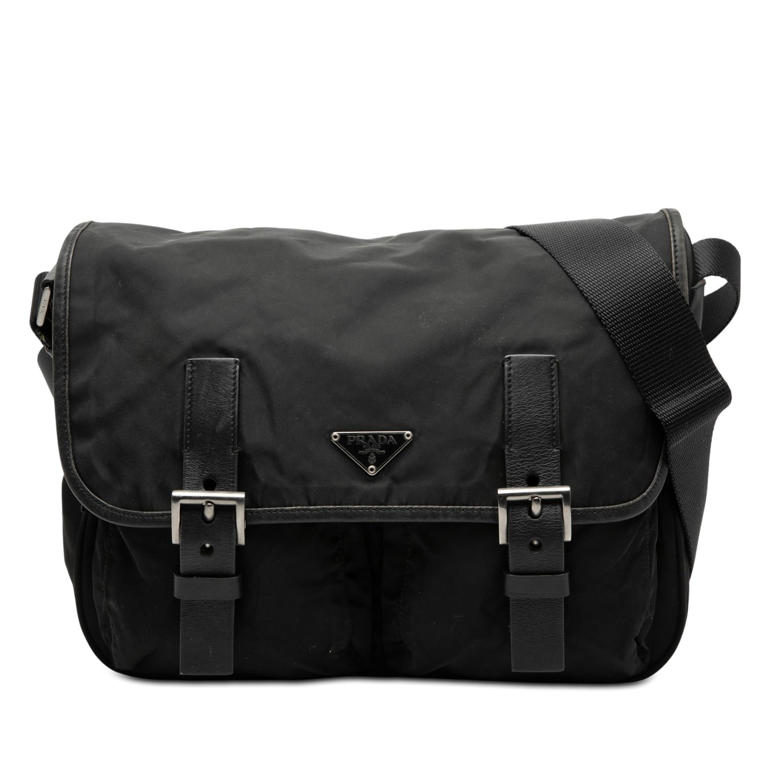 Prada Tessuto Black Nylon Messenger Bag with Double Buckle Closure: Prada Tessuto Black Nylon Messenger Bag with Double Buckle Closure This Prada Tessuto Double Buckle Messenger Bag is crafted from durable black nylon with leather trim. It features an adjustable flat 