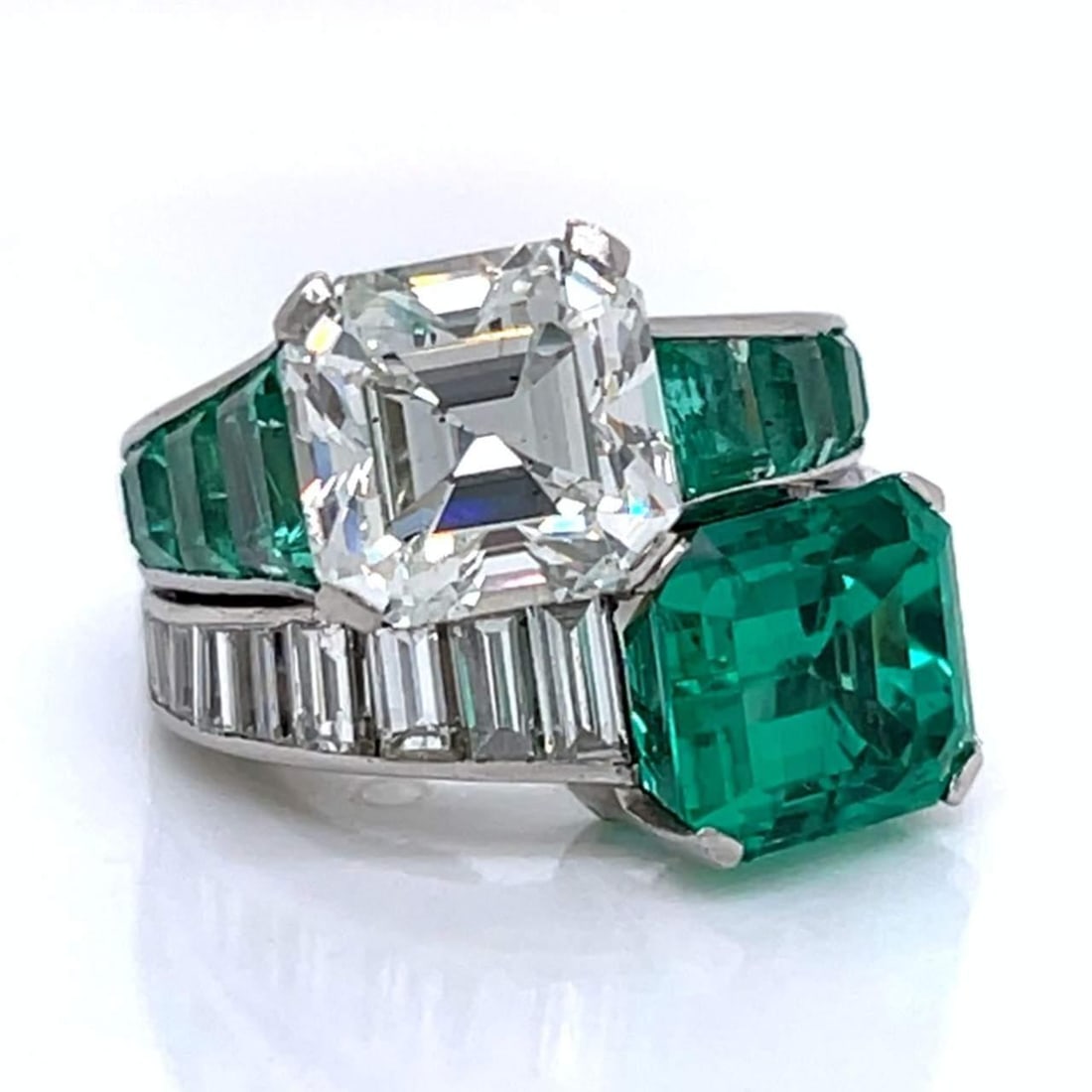 Art Deco Platinum GIA Certified Diamond Emerald Ring 4.57 Ct Diamond 7.50 Ct Emerald: Art Deco Platinum GIA Certified Diamond Emerald Ring 4.57 Ct Diamond 7.50 Ct Emerald This exquisite Art Deco ring features a stunning combination of a GIA Certified Ascher-cut diamond and a vibrant Co