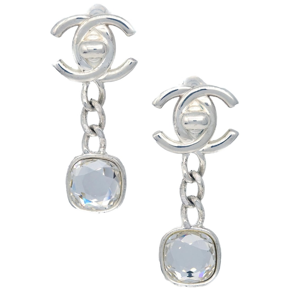 Chanel Silver Plated Dangle Clip-On Earrings with Rhinestones 97A: Chanel Silver Plated Dangle Clip-On Earrings with Rhinestones 97A Elevate your accessory collection with these stunning Chanel Dangle Turnlock Earrings. Crafted with exquisite attention to detail, the