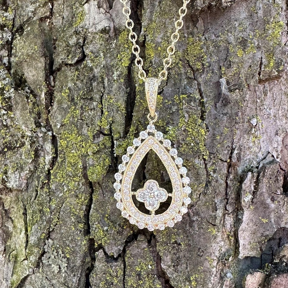 Teardrop Cluster Pendant in 14k Yellow Gold with 0.66ctw Natural Diamonds: Teardrop Cluster Pendant in 14k Yellow Gold with 0.66ctw Natural Diamonds This elegant women's pendant necklace features a pear-shaped cluster design with intricate milgrain detailing. Crafted from so