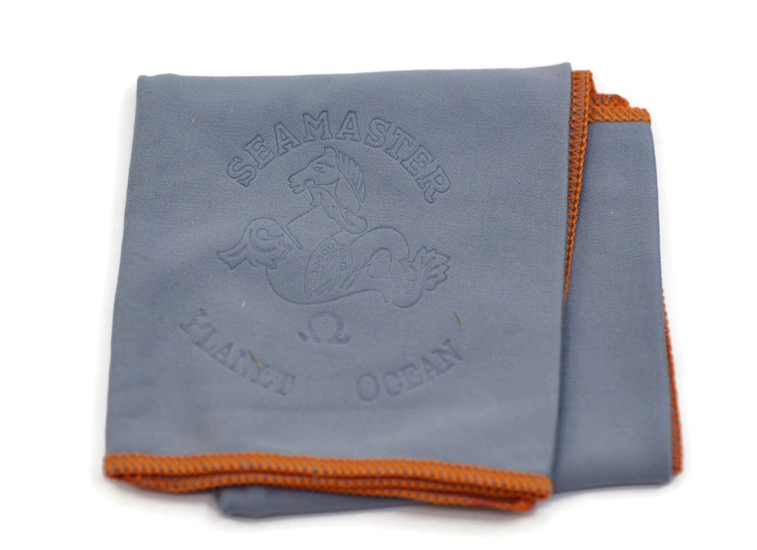 Polishing Cloth for Omega Seamaster Watch: Polishing Cloth for Omega Seamaster Watch This is a pre-owned Omega Seamaster watch cleaning cloth designed specifically for use with Omega Seamaster models. Made in Switzerland, this polishing cloth 