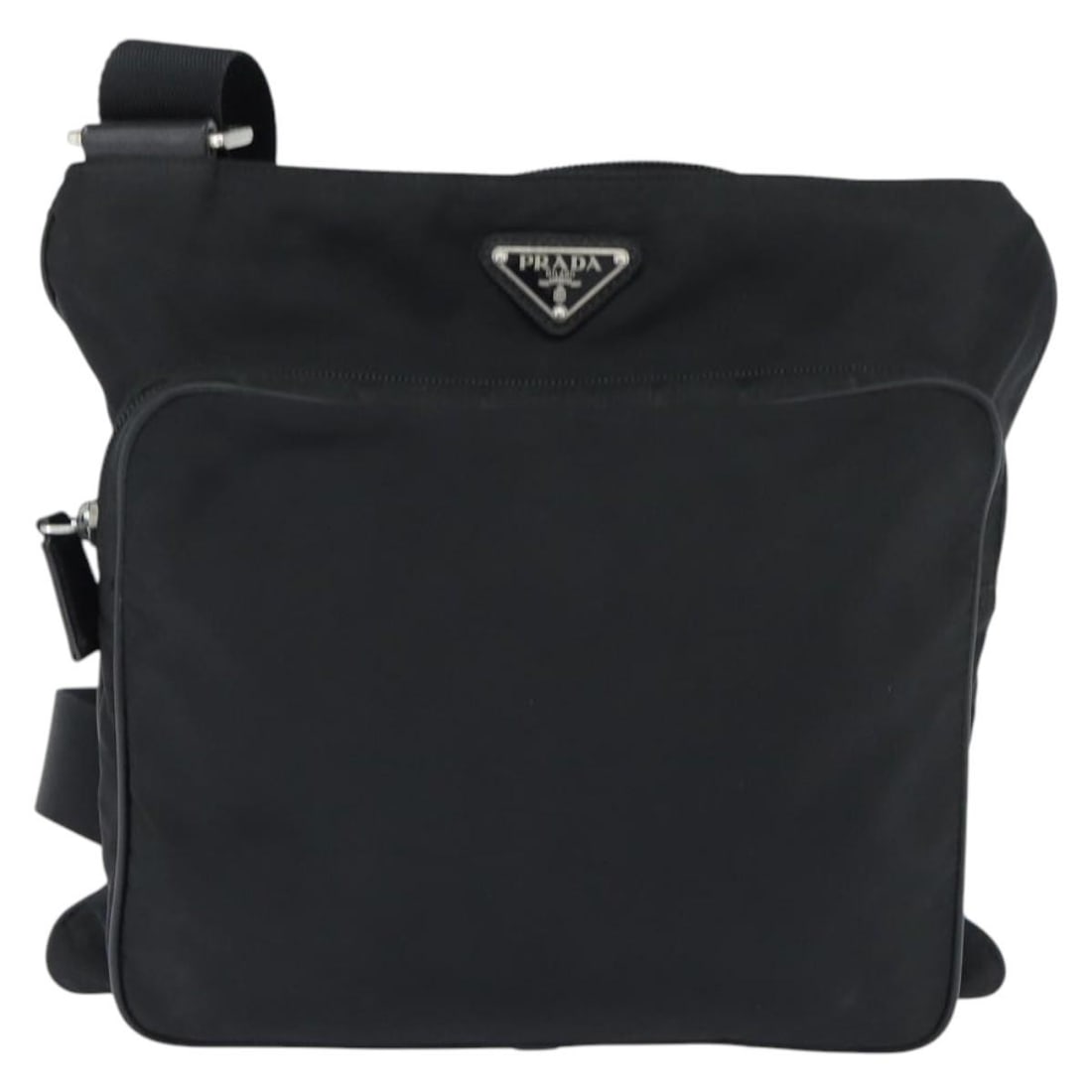 Prada Black Nylon Messenger Bag with Front Pocket: Prada Black Nylon Messenger Bag with Front Pocket This Prada Front Pocket Messenger Bag is crafted from black nylon and designed for women. It features a spacious interior with a front pocket and a sh