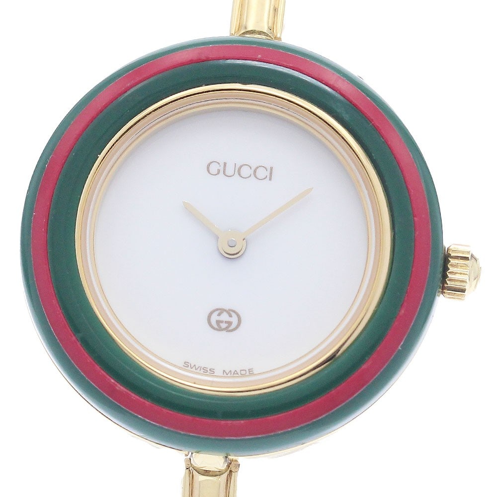 Gucci Change Bezel 1100-L Quartz Womens Wristwatch: Gucci Change Bezel 1100-L Quartz Womens Wristwatch This GUCCI 1100-L Changeable Bezel Quartz Women's Watch features a white dial and a stainless steel and gold-plated case and bracelet. The watch is p