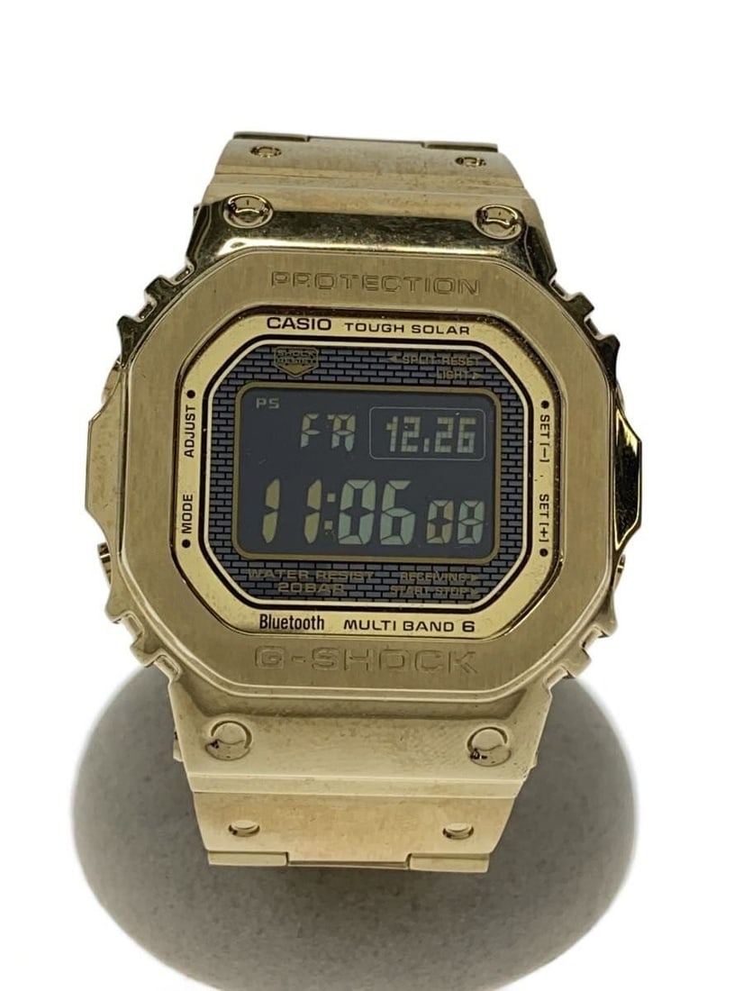 Casio G Shock Gold GMW B5000GD 9JF Wristwatch: Casio G Shock Gold GMW B5000GD 9JF Wristwatch This CASIO G-SHOCK GMW-B5000GD-9JF men's wristwatch features a gold-tone finish and a robust design. Manufactured in Japan, it is a pre-owned item with a 