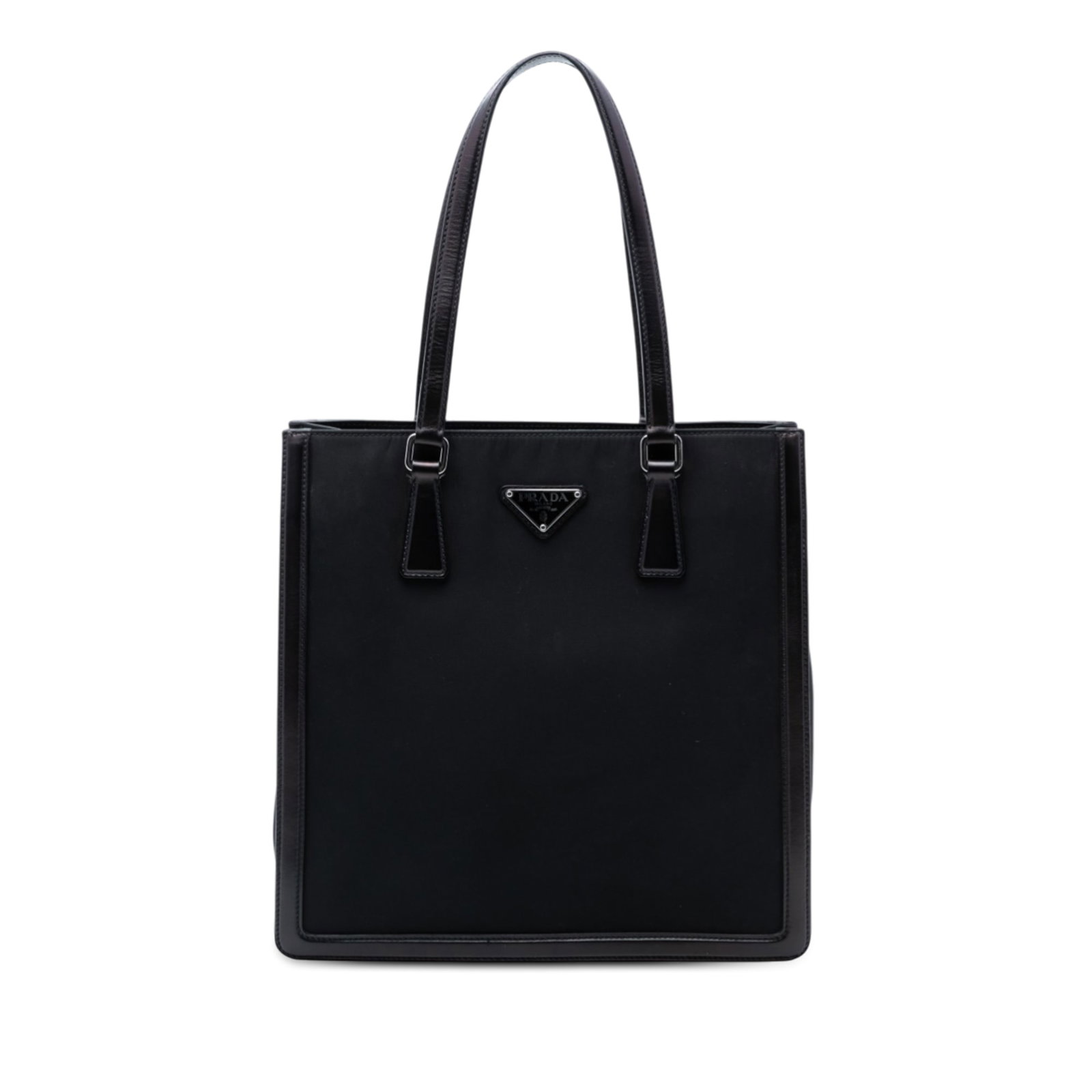 Black Tessuto Tote Bag with Leather Accents by Prada: Black Tessuto Tote Bag with Leather Accents by Prada This Prada Tessuto tote features a black nylon body with leather trim and flat leather handles. The design includes a top zip closure and an interi