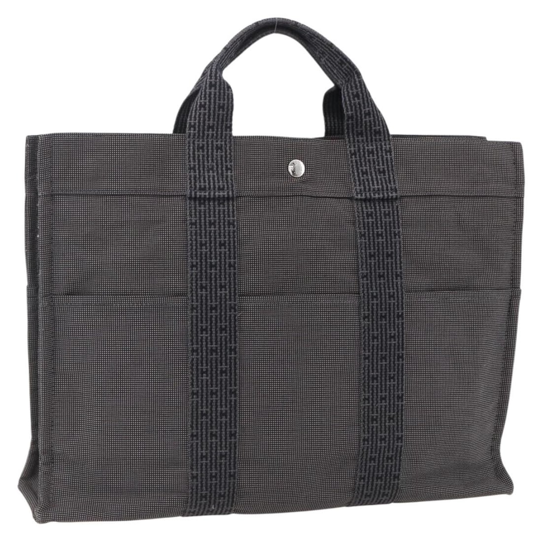 Her Line MM Canvas Tote Bag by Hermes in Gray and Silver: Her Line MM Canvas Tote Bag by Hermes in Gray and Silver This Hermes Her Line Tote MM is a women's hand bag crafted from gray and silver canvas. Made in France, it features a spacious interior and a h