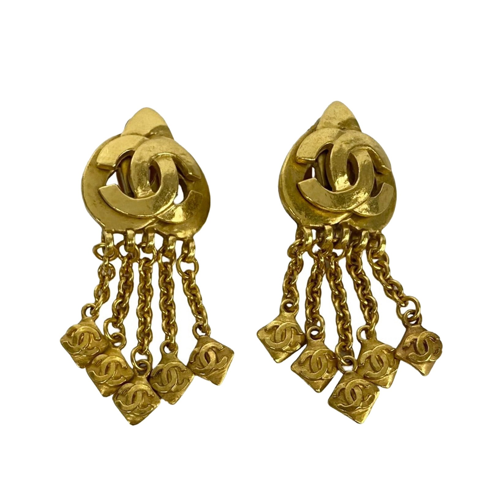Chanel CC motif gold plated metal clip on dangle earrings: Chanel CC motif gold plated metal clip on dangle earrings These Chanel clip-on earrings feature gold-plated metal bodies adorned with iconic CC charms and secure back clip-on closures. Made in France,
