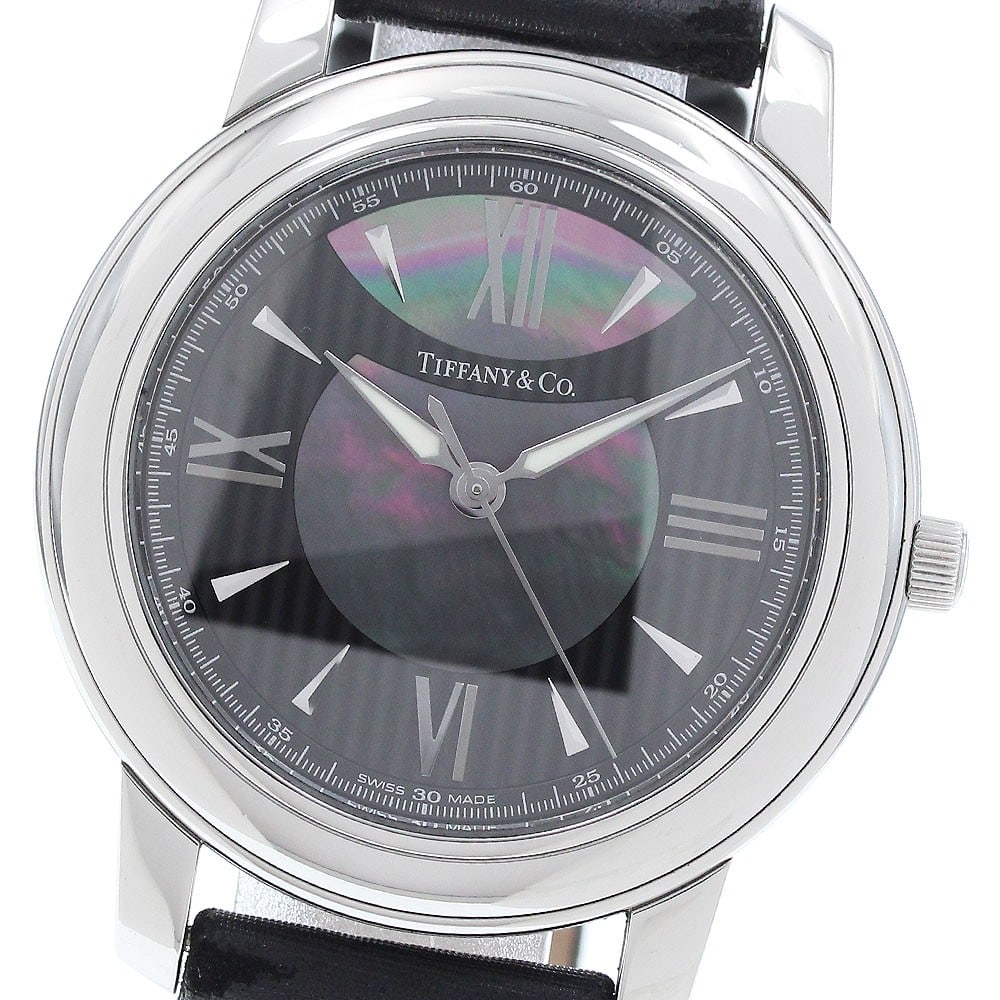 Tiffany Co Mark Round Quartz Womens Stainless Steel Watch 37mm: Tiffany Co Mark Round Quartz Womens Stainless Steel Watch 37mm This Tiffany & Co. Mark Round Quartz wristwatch is designed for women and features a stainless steel case paired with a black and shell d