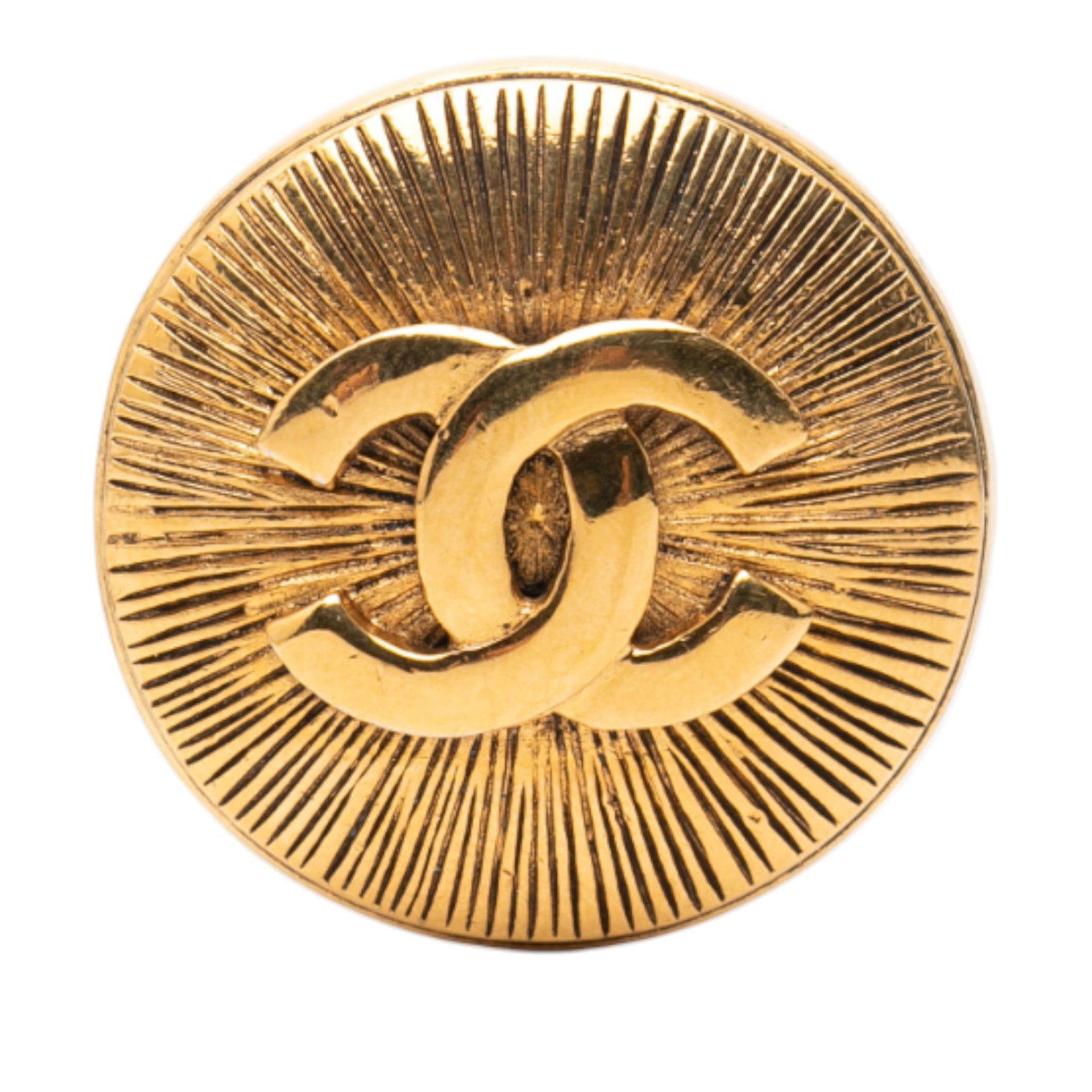 Chanel CC Logo Gold Tone Metal Round Brooch: Chanel CC Logo Gold Tone Metal Round Brooch This Chanel brooch features a gold-plated metal body with a round design and the iconic CC logo. It is equipped with a back pin closure. The brooch is class