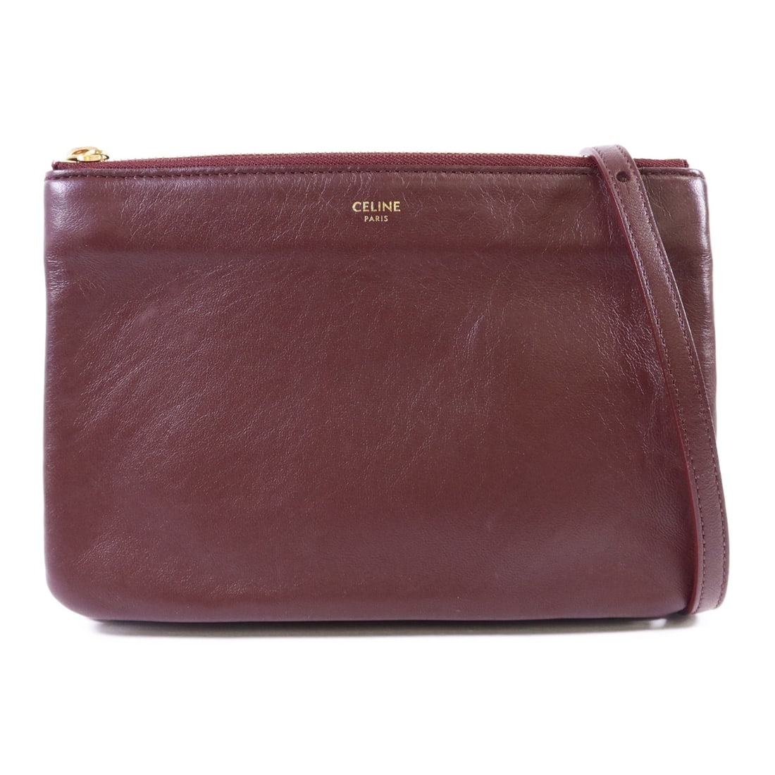 Red Calfskin Trio Shoulder Bag by CELINE with Gold Hardware: Red Calfskin Trio Shoulder Bag by CELINE with Gold Hardware This Celine Trio shoulder bag is crafted from red calfskin leather and features a sleek, compact design. Made in France, it offers a stylish