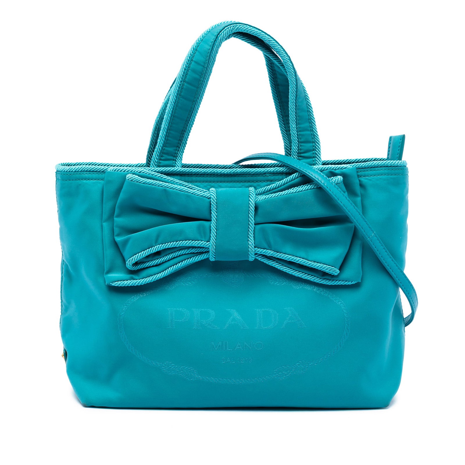 Prada Tessuto Canapa Blue Fabric Satchel with Bow and Logo Detail: Prada Tessuto Canapa Blue Fabric Satchel with Bow and Logo Detail This Prada Tessuto Canapa Logo Bow Satchel features a blue nylon body with a distinctive nylon bow detail, flat handles, and a detacha