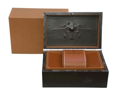 Breitling presentation box 10X7X5 inches: Breitling presentation box 10X7X5 inches This is a Breitling large watch box, measuring 10 x 7 x 5 inches. It features a leather interior and an embossed aircraft design on the lid, accompanied by a b