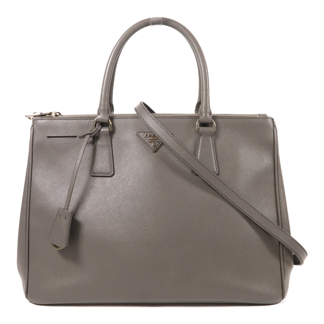 PRADA 2 Way Shoulder Bag Calfskin Leather Gray Made in Italy: PRADA 2 Way Shoulder Bag Calfskin Leather Gray Made in Italy This PRADA 2 Way Shoulder Bag is crafted from high-quality calfskin leather in a sophisticated gray color. The versatile design allows it t
