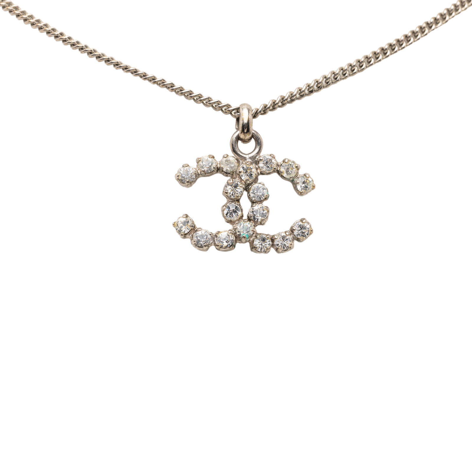 Chanel CC Pendant Necklace with Silver Tone Rhinestone Detailing: Chanel CC Pendant Necklace with Silver Tone Rhinestone Detailing This Chanel necklace features a silver-tone metal pendant adorned with rhinestones, suspended from a matching silver-tone chain and sec
