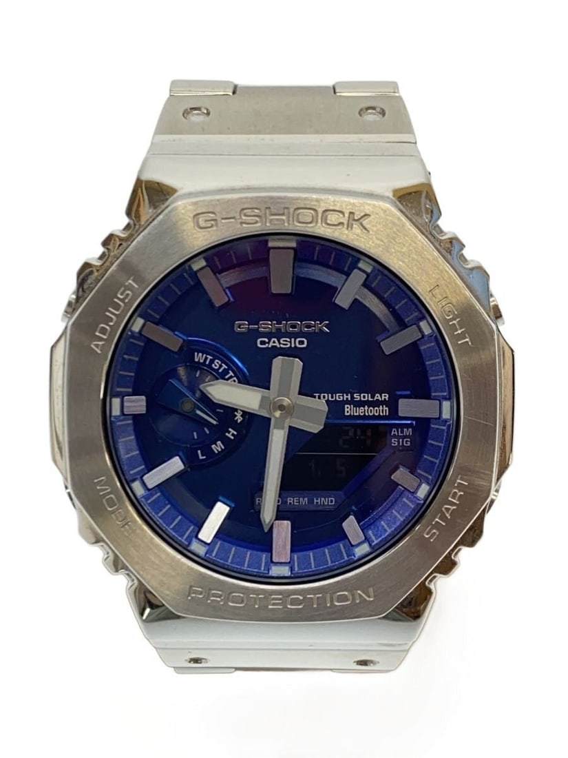 Casio G Shock Blue Stainless Steel Wristwatch GM B2100AD 2AJF: Casio G Shock Blue Stainless Steel Wristwatch GM B2100AD 2AJF This CASIO G-SHOCK GM-B2100AD-2AJF is a men's wristwatch featuring a blue stainless steel case and band. The watch is pre-owned and shows 