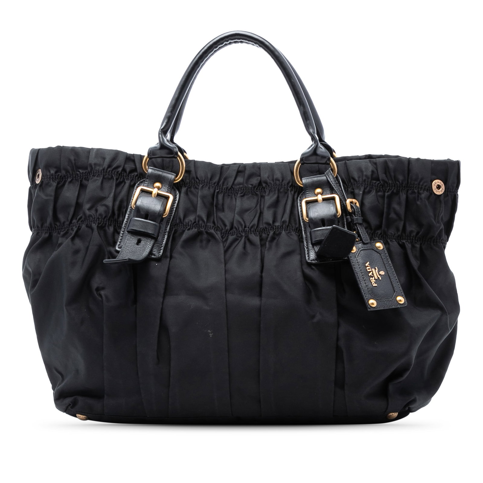 Black Prada Tessuto Gaufre Nylon Tote with Leather Trim: Black Prada Tessuto Gaufre Nylon Tote with Leather Trim This Prada Tessuto Gaufre Tote features a gathered nylon body with leather trim and rolled leather handles. It has an open top with a snap closu