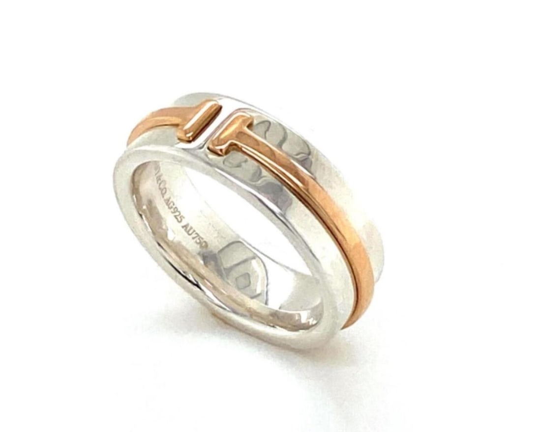 Tiffany T Two 18k Rose Gold Sterling Silver Band Ring Size 4.5: Tiffany T Two 18k Rose Gold Sterling Silver Band Ring Size 4.5 This Tiffany & Co. T Two narrow band ring is crafted from sterling silver and 18k rose gold, showcasing the brand's iconic T motif in a m