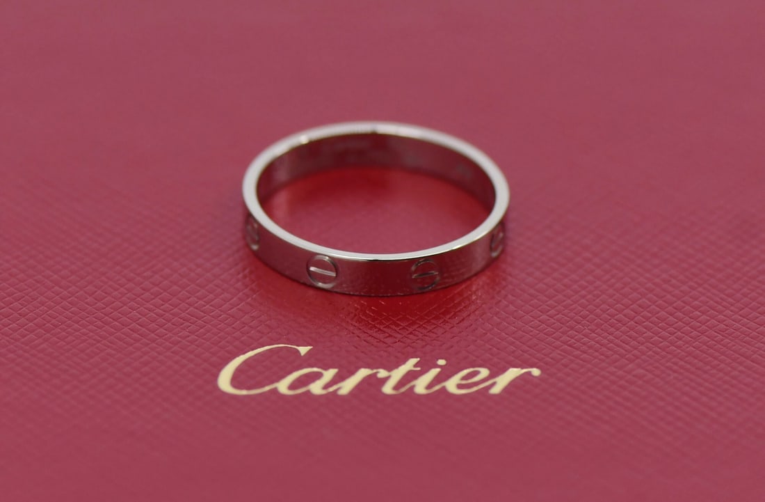 Love Collection Small 18K White Gold Band by Cartier Size 60 with Box and Papers: Love Collection Small 18K White Gold Band by Cartier Size 60 with Box and Papers This Cartier SM Love ring is crafted from 18k white gold and features a classic design without a main stone. The ring
