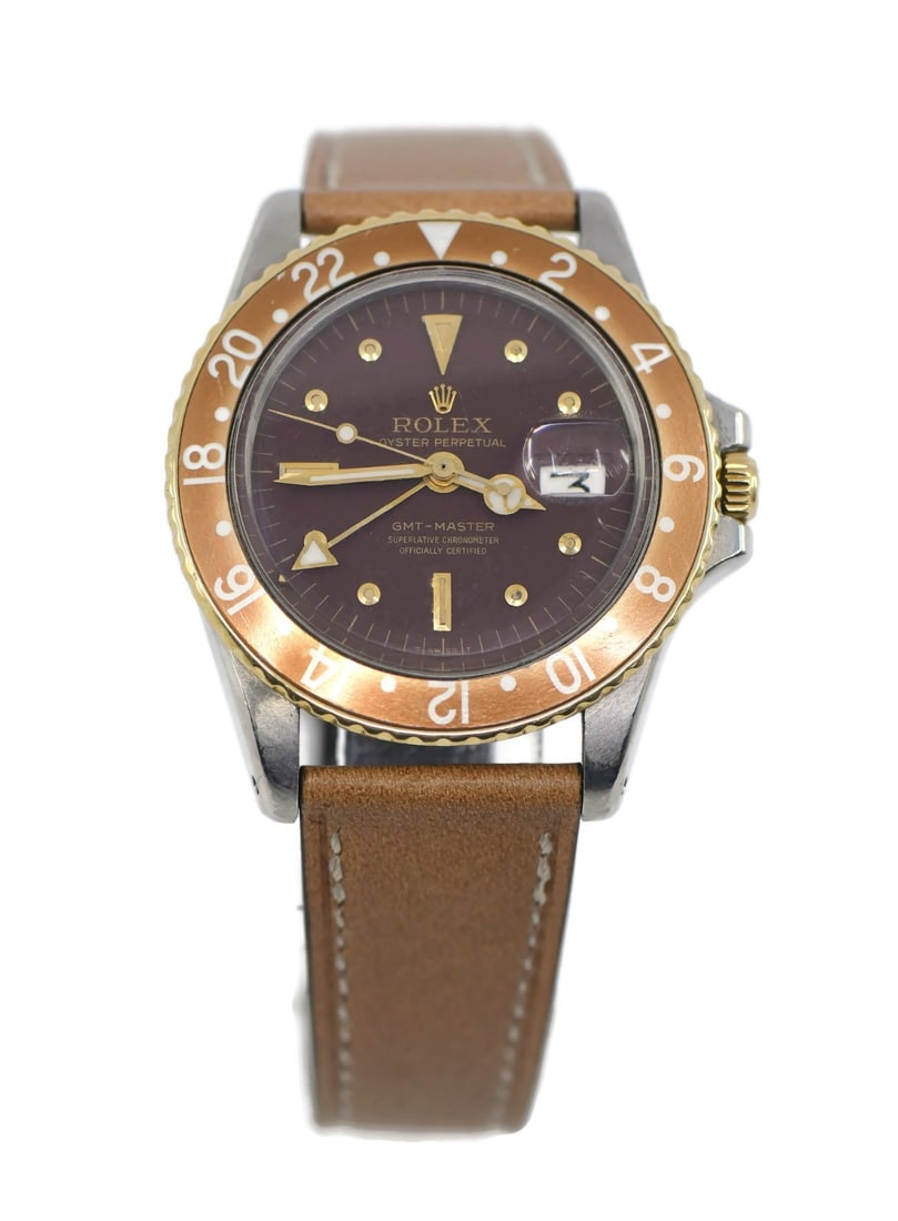 Rolex GMT-Master Root Beer 18K Stainless Steel Watch Ref 1675 40mm: Rolex GMT-Master Root Beer 18K Stainless Steel Watch Ref 1675 40mm Introducing the iconic Rolex GMT-Master Root Beer wristwatch, a perfect blend of luxury and functionality. Crafted in 1972, this exqu