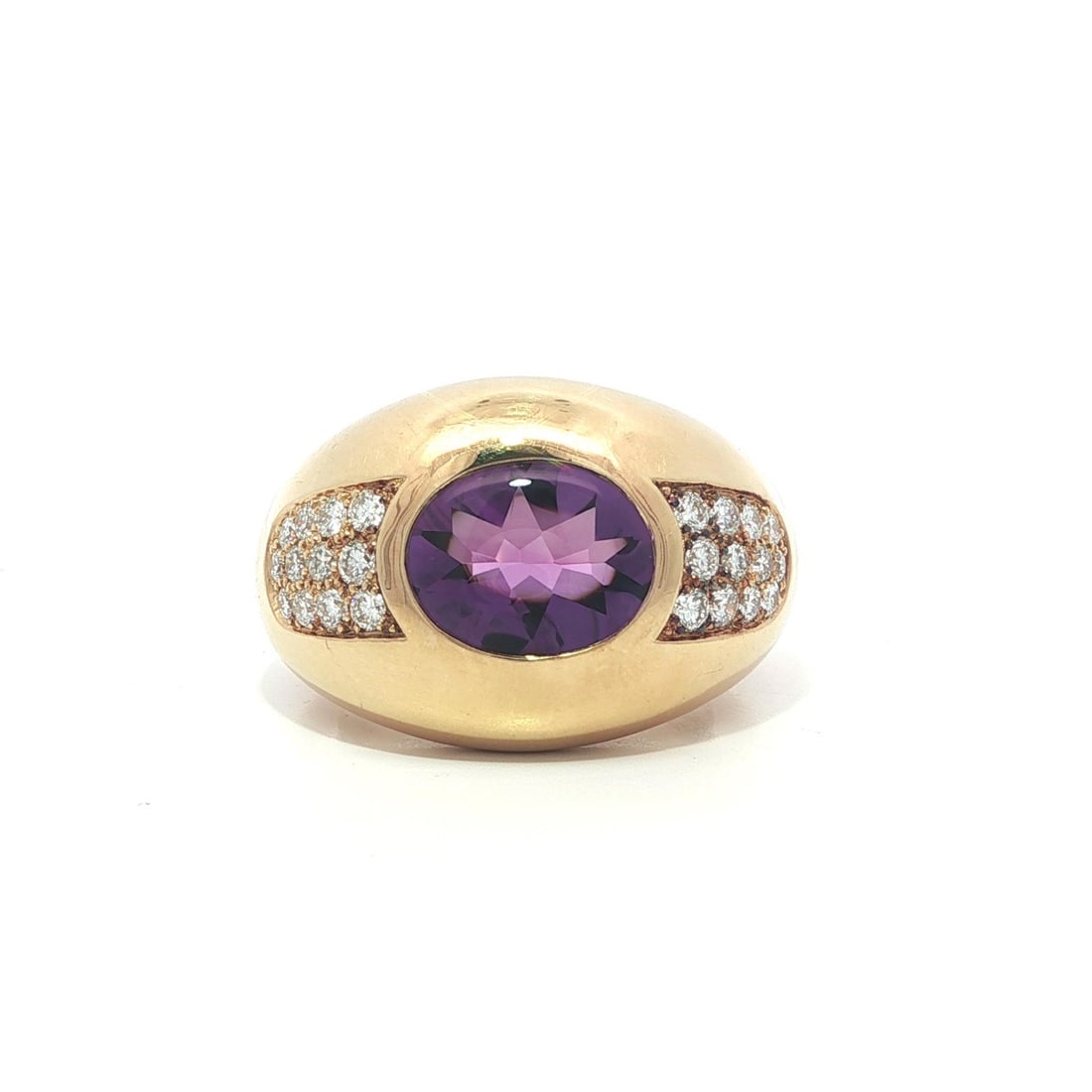 Wide 18k Yellow Gold Band Ring With Oval Amethyst and Diamond Details: Wide 18k Yellow Gold Band Ring With Oval Amethyst and Diamond Details This Mauboussin French ring features an oval-cut natural amethyst accented by round brilliant-cut natural diamonds. Crafted from s