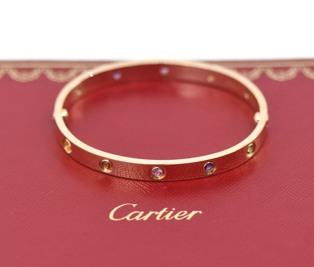 Cartier 18K Rose Gold Love Bracelet with Sapphire Size 17 Authentic: Cartier 18K Rose Gold Love Bracelet with Sapphire Size 17 Authentic This exquisite Cartier Love Bracelet is crafted from 18K rose gold and features a stunning gemstone design. The bracelet, themed aro