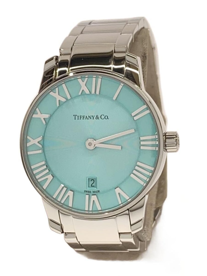 Tiffany Co Atlas Blue Dial Quartz Wristwatch: Tiffany Co Atlas Blue Dial Quartz Wristwatch This Tiffany & Co. Atlas Quartz women's wristwatch features a blue dial and exhibits slight signs of wear consistent with typical used condition. The watch