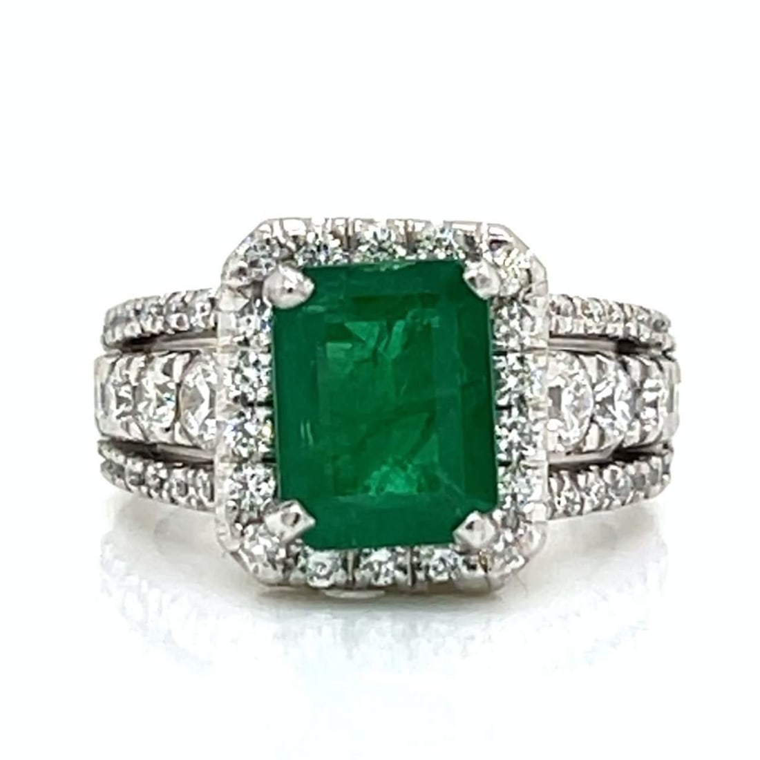 Platinum Ring with 3.25 Ct Emerald and 54 Diamonds: Platinum Ring with 3.25 Ct Emerald and 54 Diamonds This stunning Platinum ring features a captivating approximately 3.25 Ct. Emerald, elegantly complemented by 54 sparkling Diamonds with an approximat