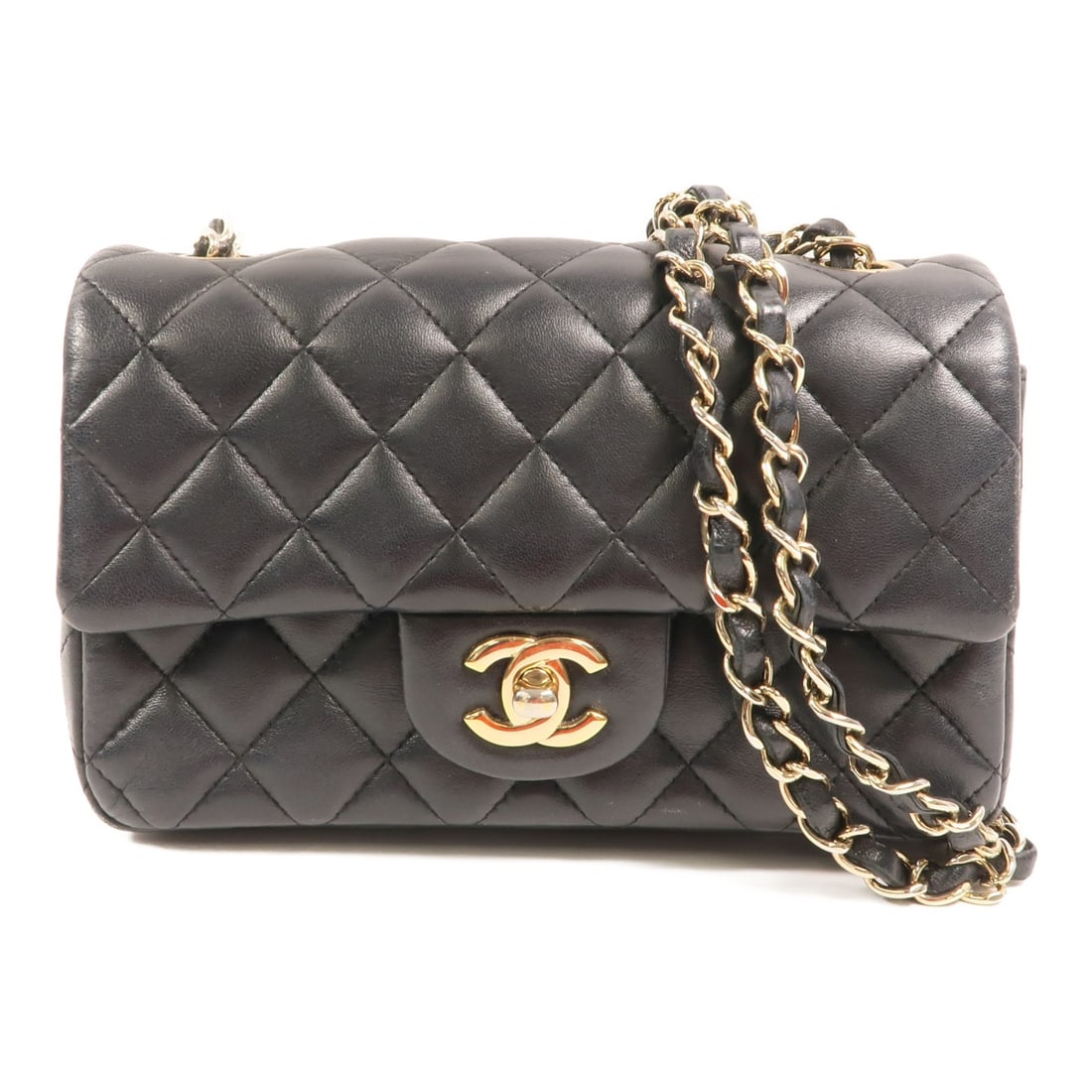 Navy Lambskin Shoulder Bag with CC Logo and Gold Hardware by CHANEL: Navy Lambskin Shoulder Bag with CC Logo and Gold Hardware by CHANEL This CHANEL shoulder bag features a classic CC design with gold tone chain detailing and is crafted from luxurious navy lambskin lea