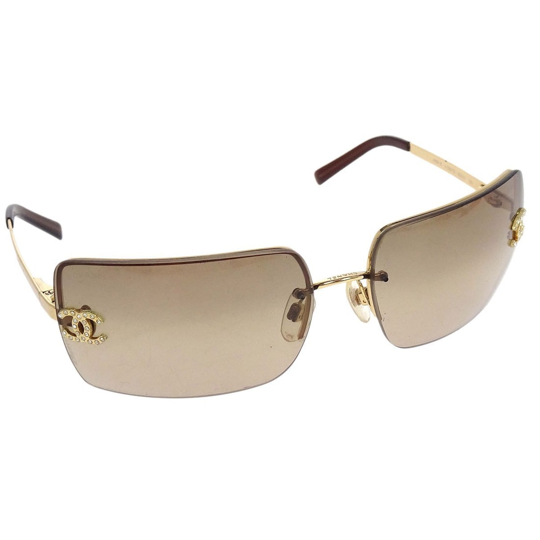 CHANEL CC Logo Brown Lens Gold Frame Women Sunglasses: CHANEL CC Logo Brown Lens Gold Frame Women Sunglasses These Chanel sunglasses feature a gold acrylic frame adorned with rhinestone accents and brown acrylic lenses. Designed for women, they showcase t