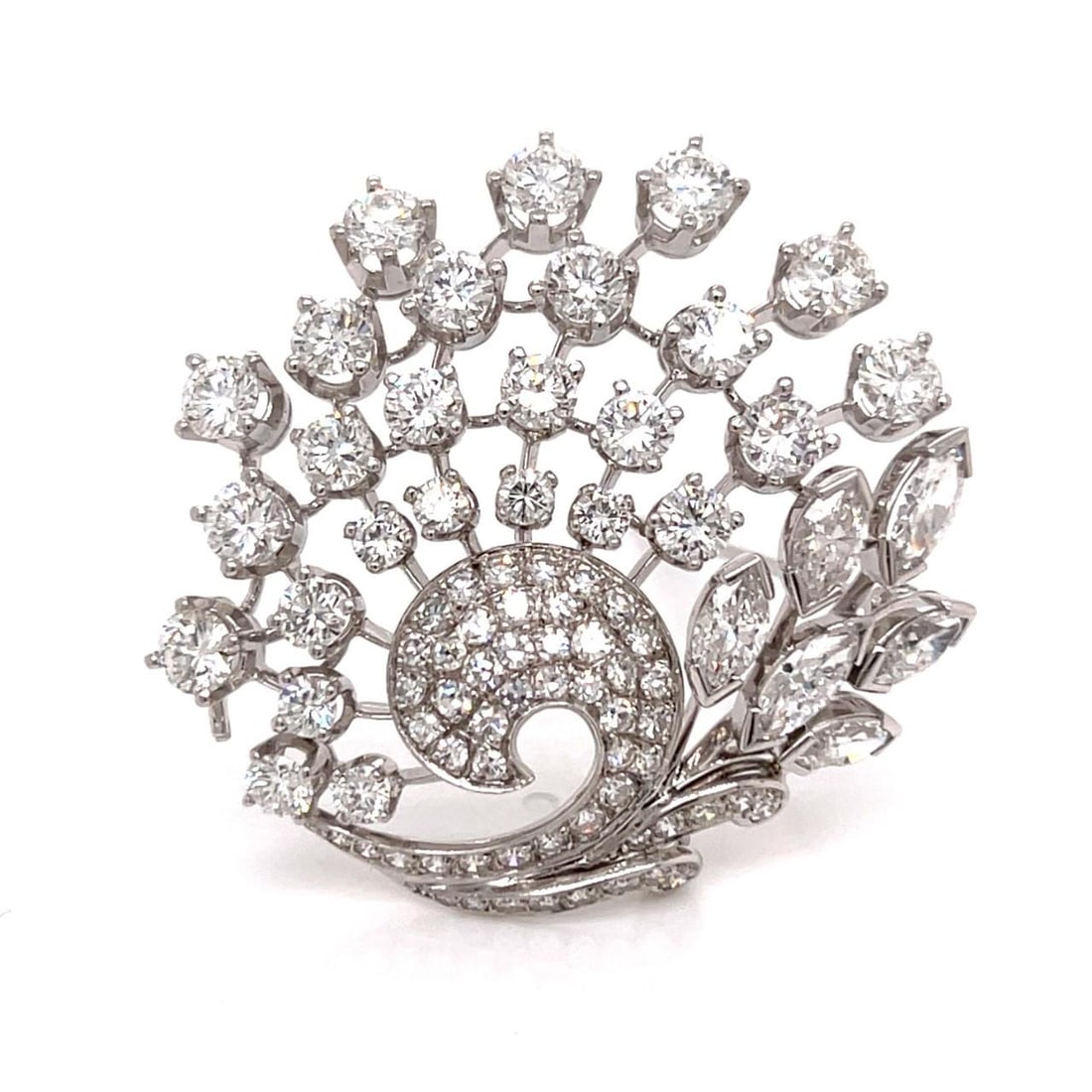1960s Platinum Brooch with 9.60 Carat Diamonds by Birks: 1960s Platinum Brooch with 9.60 Carat Diamonds by Birks This 1960s platinum brooch by Birks features an impressive arrangement of diamonds totaling approximately 9.60 carats. The brooch is set with 6 