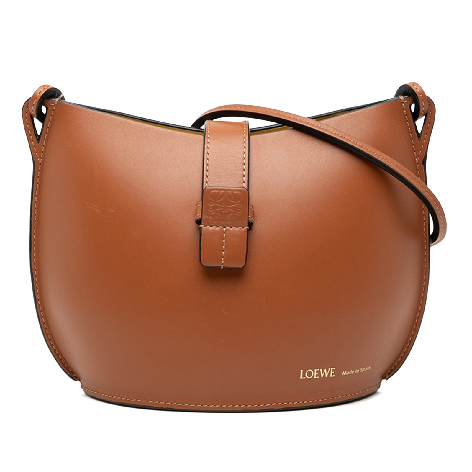 Loewe Brown Leather Bucket Bag with Molded Design and Flap Tab: Loewe Brown Leather Bucket Bag with Molded Design and Flap Tab This LOEWE bucket bag features a molded leather body in brown, a flat leather strap, and an open top with a flap tab and slip-through clo
