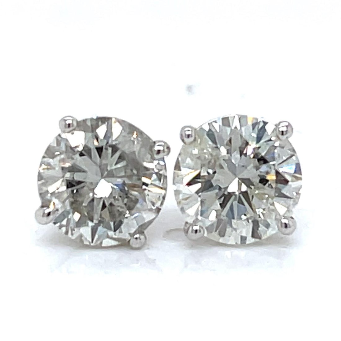 Diamond Stud Earrings in 14K White Gold Totaling 4.46 Carats: Diamond Stud Earrings in 14K White Gold Totaling 4.46 Carats These stud earrings are crafted from 14K white gold and feature two diamonds with a combined total weight of 4.46 carats. The diamonds are 