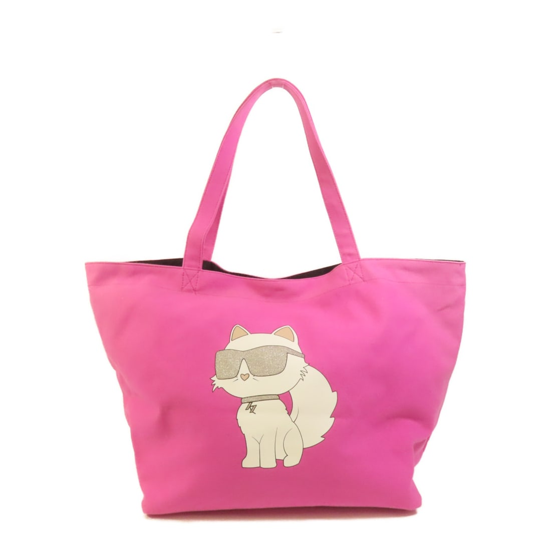 Pink Canvas Tote by KARL LAGERFELD with Shoulder Strap: Pink Canvas Tote by KARL LAGERFELD with Shoulder Strap This KARL LAGERFELD tote bag features a stylish pink canvas exterior and offers both function and fashion as a shoulder or tote bag. Crafted in C