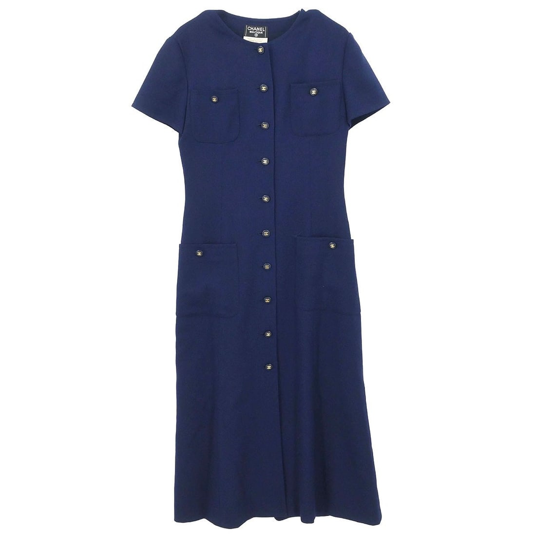 CHANEL navy wool shirt dress FR 38 short sleeve: CHANEL navy wool shirt dress FR 38 short sleeve This vintage Chanel short sleeve shirt dress is crafted from 100% wool in a classic navy color. Designed in a knee-length silhouette, it features a butt