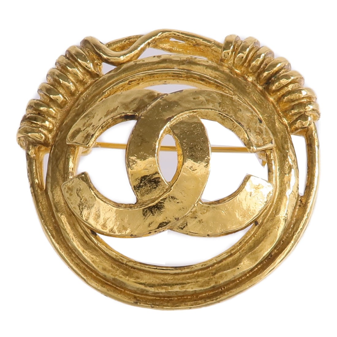 CHANEL Gold CC Pin Brooch: CHANEL Gold CC Pin Brooch This CHANEL brooch features the iconic CC logo in a gold-toned metal finish. Designed for women, this elegant accessory is crafted in France and does not include any stones. 