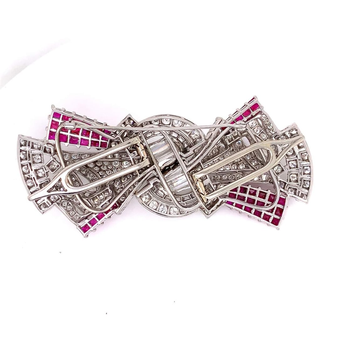 Art Deco Platinum Ruby Diamond Brooch 3.25 x 1.5 inches: Art Deco Platinum Ruby Diamond Brooch 3.25 x 1.5 inches This exquisite Art Deco brooch showcases a stunning combination of Burma rubies and diamonds, crafted in luxurious platinum. The centerpiece fea