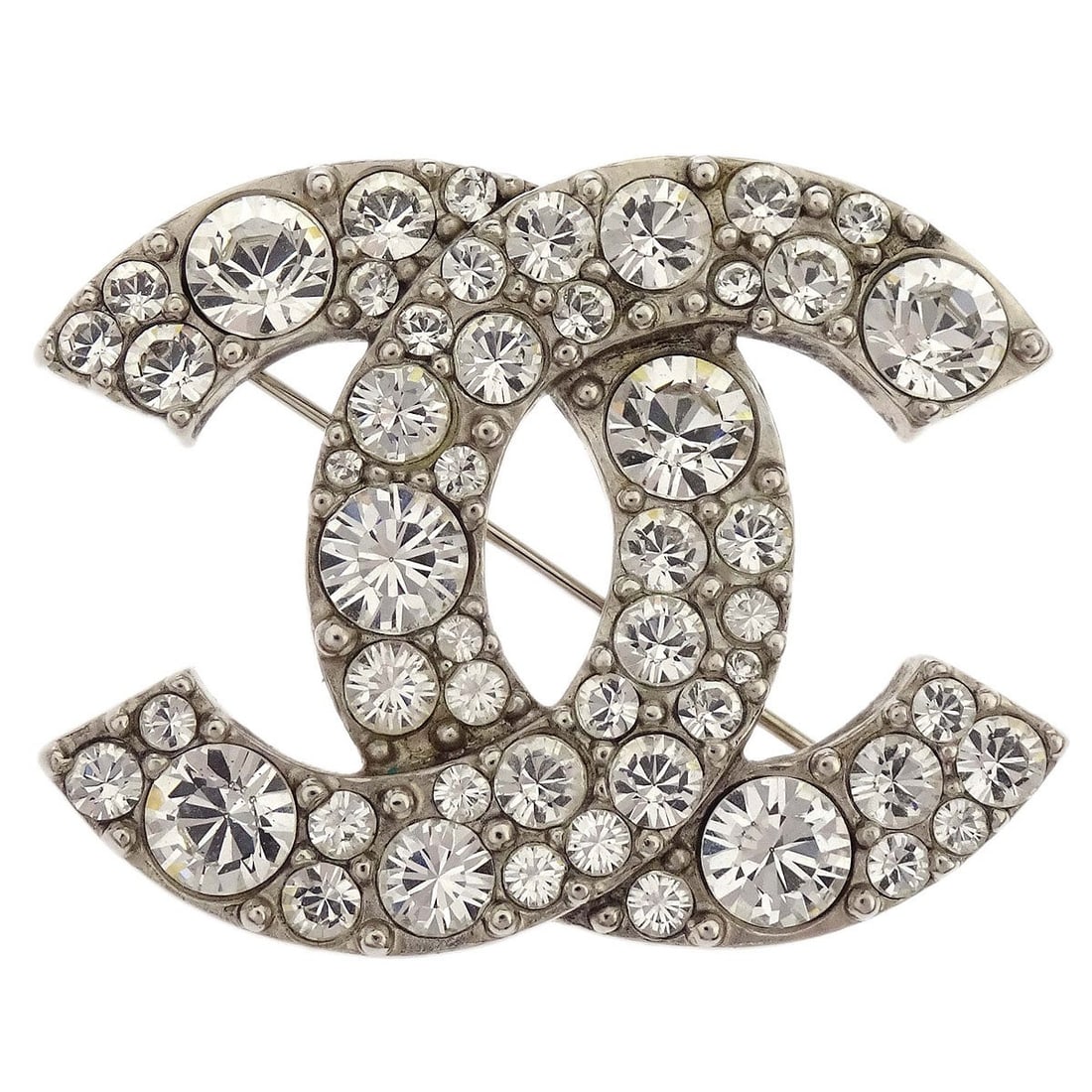 Chanel Silver Plated CC Rhinestone Brooch Pin A12W: Chanel Silver Plated CC Rhinestone Brooch Pin A12W This Chanel CC brooch features sparkling rhinestones set in a silver-plated finish, showcasing the iconic interlocking CC logo. Crafted in France, th