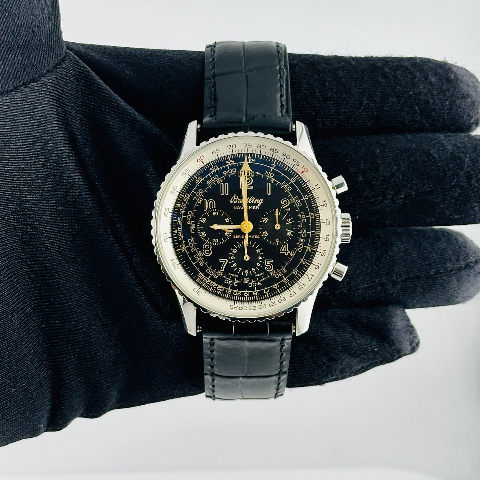 Navitimer A11022.1 Watch with Black and Yellow Arabic Dial on Leather Strap: Navitimer A11022.1 Watch with Black and Yellow Arabic Dial on Leather Strap This Breitling Navitimer watch features a black dial with yellow Arabic markers and a rotating bezel. It is paired with a le