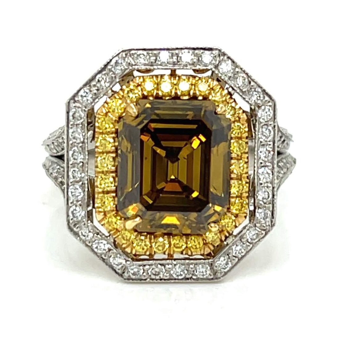 GIA Certified 3.43 Ct Fancy Yellow-Brown Diamond Ring in 18K Gold & Platinum: GIA Certified 3.43 Ct Fancy Yellow-Brown Diamond Ring in 18K Gold & Platinum This stunning ring features a captivating 3.43 Ct. GIA Certified Emerald-cut Fancy Deep Yellow-Brown Diamond, artfully set 