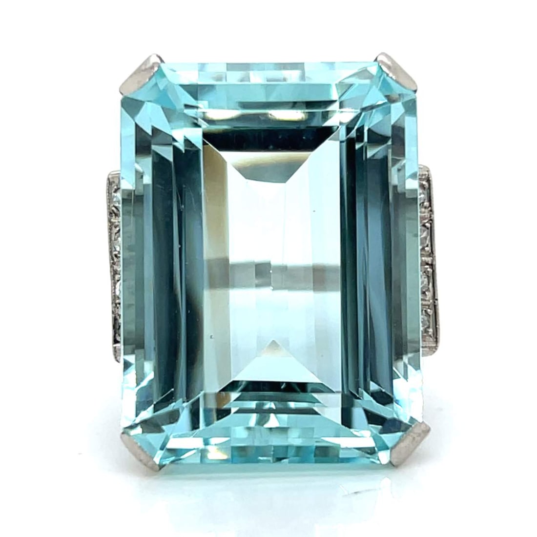 Art Deco Platinum Ring 55 Ct Aquamarine 8 Diamonds F-G SI1-I1: Art Deco Platinum Ring 55 Ct Aquamarine 8 Diamonds F-G SI1-I1 This stunning Art Deco ring showcases a remarkable approximately 55.00 ct. aquamarine, elegantly set in platinum. The ring also features 8