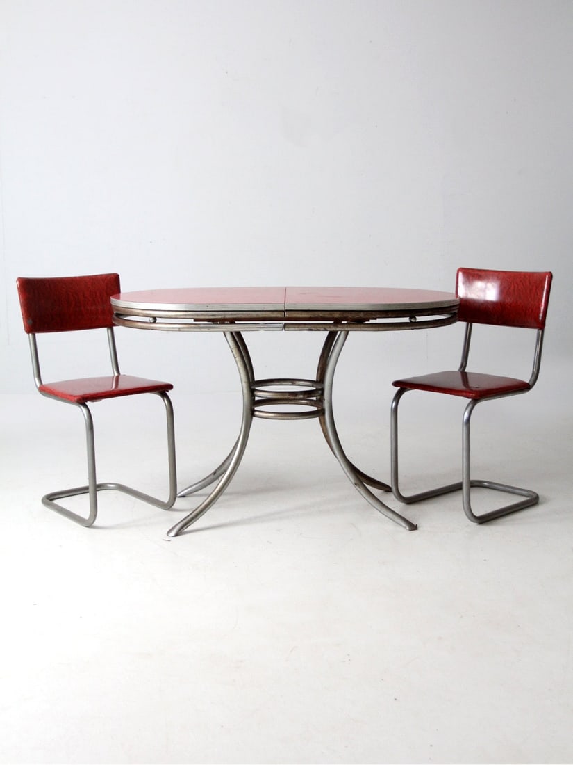 Vintage Red Laminate Dining Table and Chairs Mid-Century Modern Set: Vintage Red Laminate Dining Table and Chairs Mid-Century Modern Set This vintage mid-century dinette set showcases a red laminate tabletop supported by a tubular steel base and cantilevered chairs uph