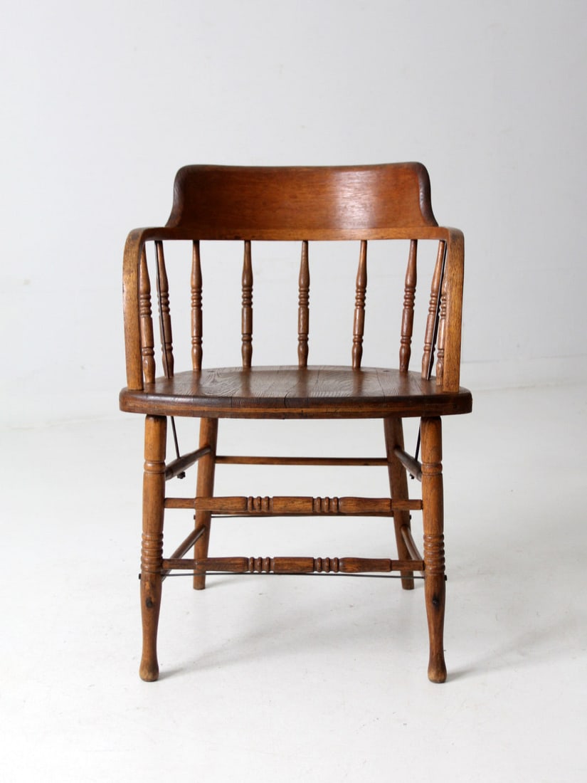 Antique Captain's Chair Early American Design with Patina: Antique Captain's Chair Early American Design with Patina This antique Captain's chair showcases the elegant design of early American craftsmanship, featuring a gracefully curved backrest and a classi