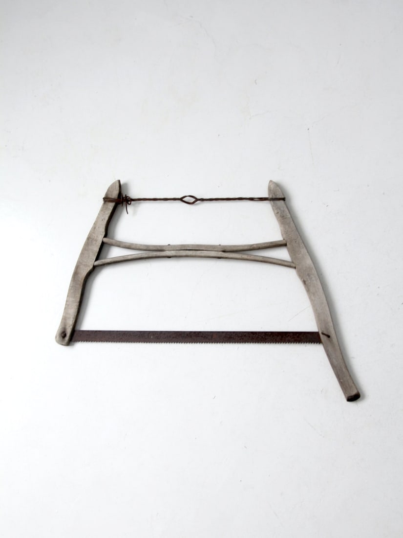 Vintage 32 Inch Antique Buck Saw with Wood Frame and Metal Blades: Vintage 32 Inch Antique Buck Saw with Wood Frame and Metal Blades Discover this charming antique buck saw, a true testament to craftsmanship. This primitive tool features a sturdy wooden frame complem