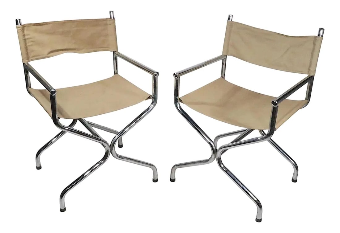 Pair of Vintage Chrome Directors Chairs with Canvas Seats 1960s: Pair of Vintage Chrome Directors Chairs with Canvas Seats 1960s This chic pair of vintage Mid Century chrome Directors chairs features durable canvas sling seats and backs. Crafted in the USA during t