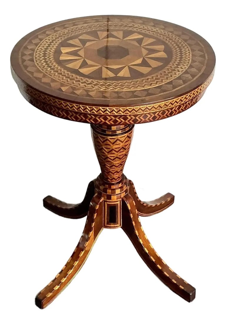 Bohemian Marquetry Accent Table with Geometric Wood Inlay Design: Bohemian Marquetry Accent Table with Geometric Wood Inlay Design This vintage marquetry wood side table features intricate inlay work forming geometric patterns across its circular top and elegantly t