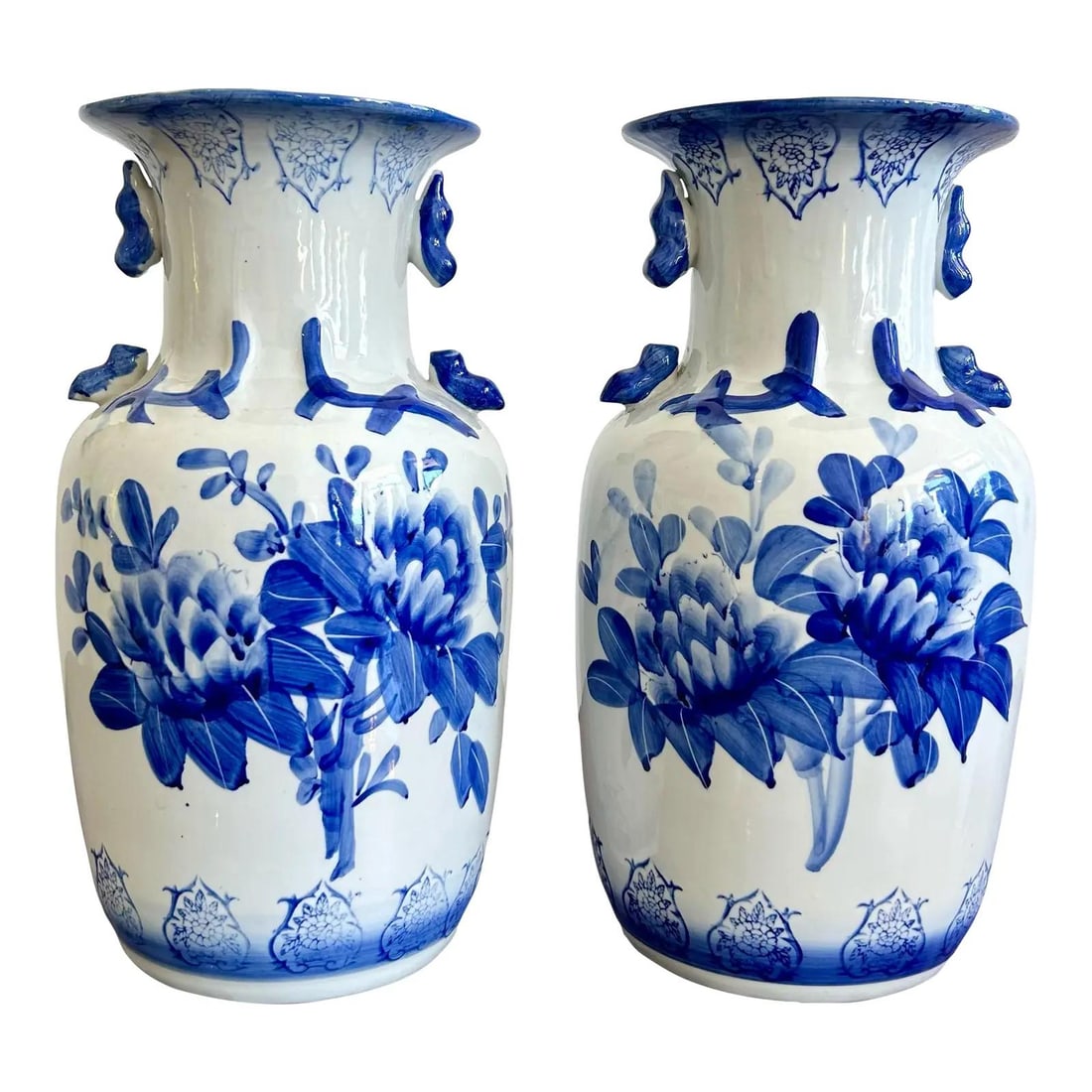 Pair of Chinese Style Cobalt Blue Floral Porcelain Vases with Animal Handles: Pair of Chinese Style Cobalt Blue Floral Porcelain Vases with Animal Handles This vintage pair of blue and white porcelain vases features classic Chinese-inspired artistry with bold cobalt floral moti