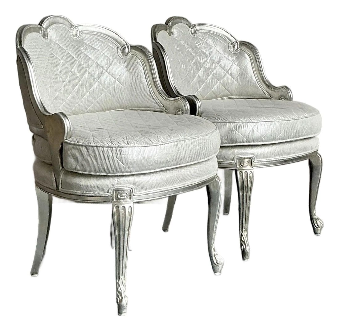 Pair of Silver Finish Regency Baroque Quilted Upholstery Lounge Chairs: Pair of Silver Finish Regency Baroque Quilted Upholstery Lounge Chairs This pair of vintage lounge chairs showcases the opulent style of Regency and Baroque design with elegantly carved frames finishe