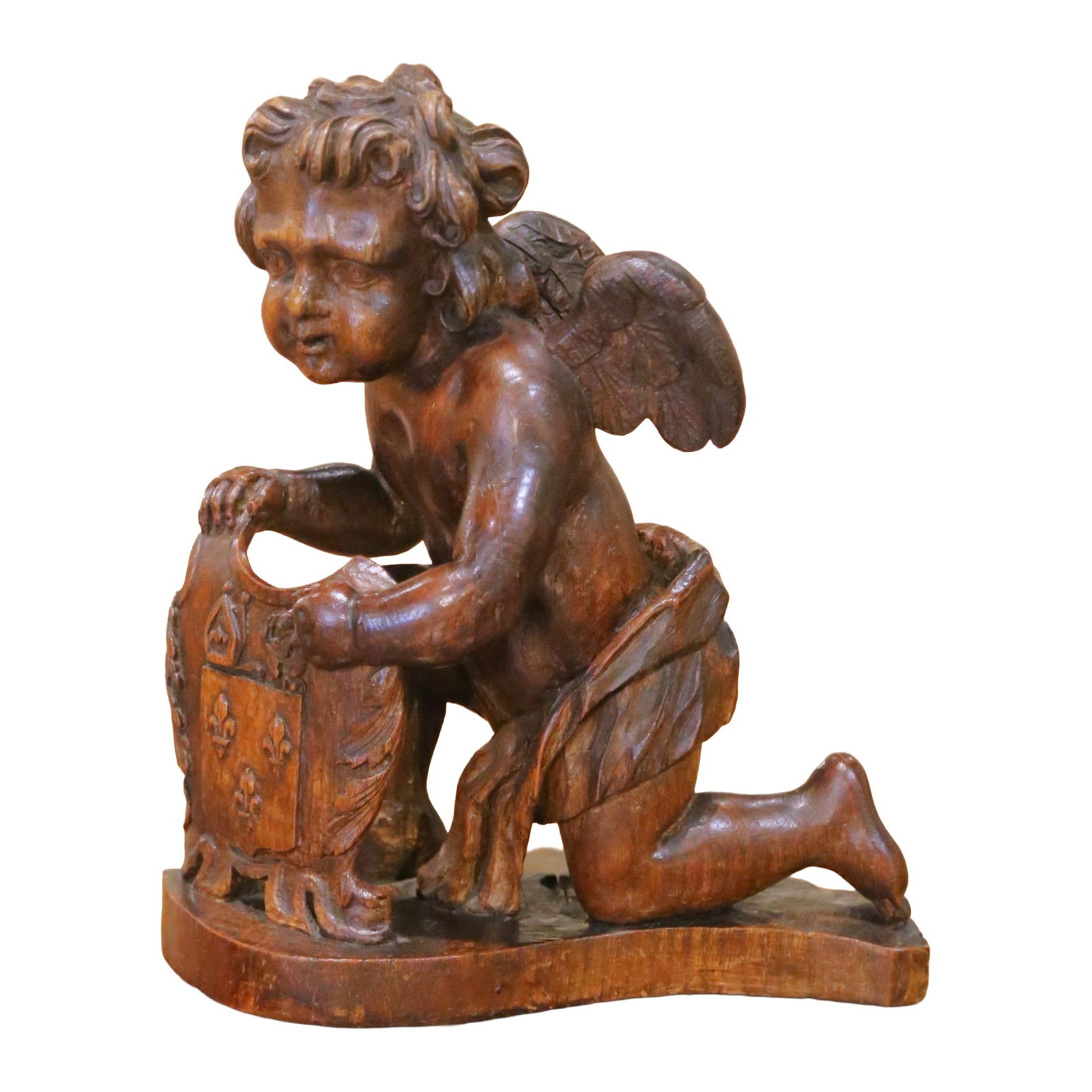 French Oak Putto Sculpture with Fleur-de-Lys Shield Late 18th Century: French Oak Putto Sculpture with Fleur-de-Lys Shield Late 18th Century This late 18th century French sculpture is a hand-carved oak depiction of a kneeling winged putto presenting a heraldic shield ado