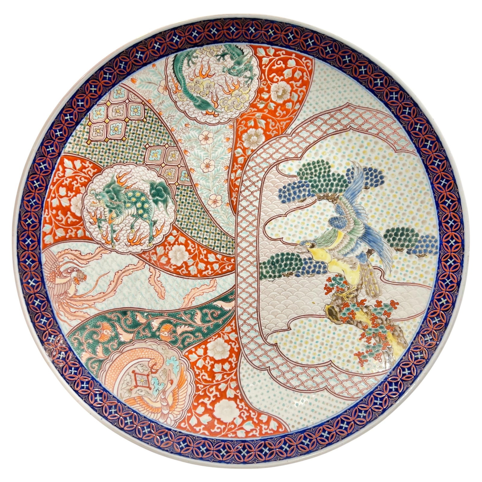 Meiji Period 22 Inch Porcelain Imari Charger from Japan: Meiji Period 22 Inch Porcelain Imari Charger from Japan This is an antique Japanese Imari porcelain charger from the Meiji period, crafted around 1900. The charger features traditional Imari decorativ